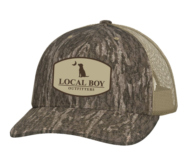 Local Boy Pocket Badge Trucker Hat - Mossy Oak Bottomland